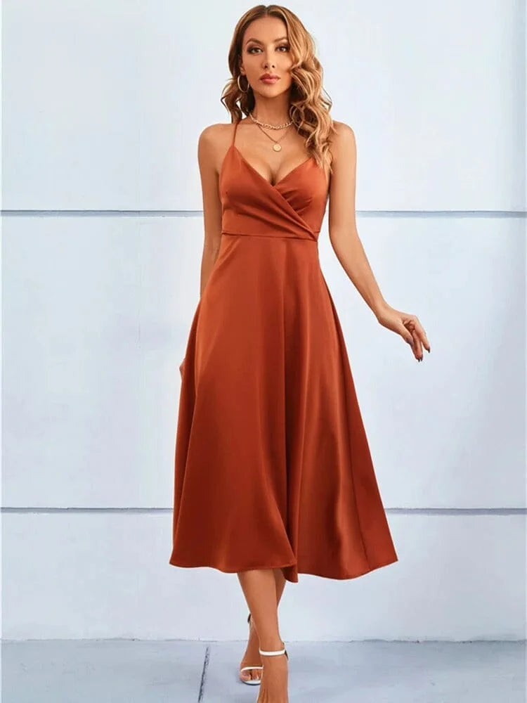 Maroon silk midi dress with sleeveless design and adjustable straps, perfect for chic and elegant occasions.