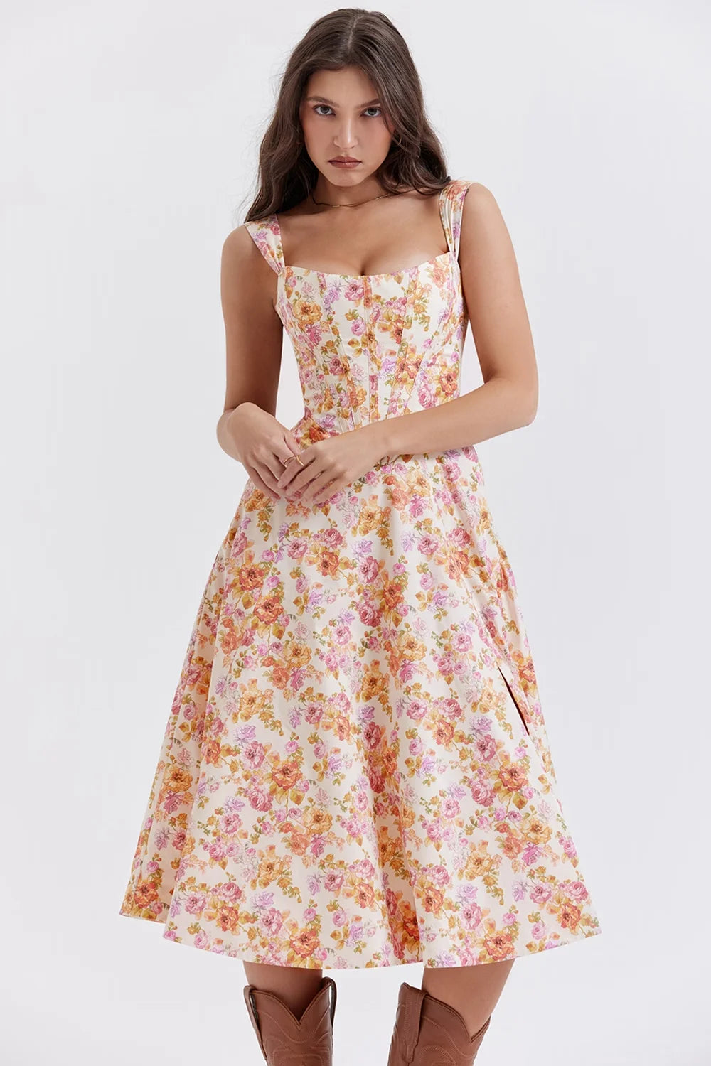 Pink floral midi dress with shapely seams. Features a soft and flowy fabric perfect for summer events and gatherings.