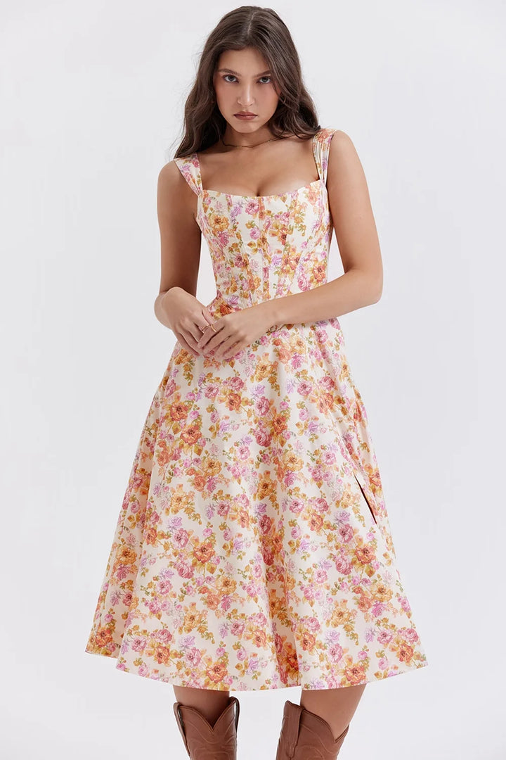 Pink floral midi dress with shapely seams. Features a soft and flowy fabric perfect for summer events and gatherings.