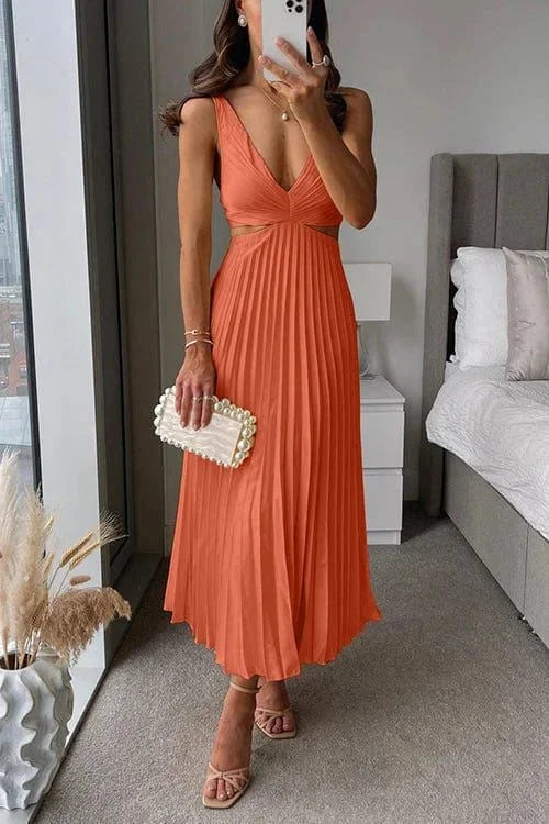 Orange midi dress with pleated design and cut-out accents. Effortlessly elegant and stylish for any occasion.