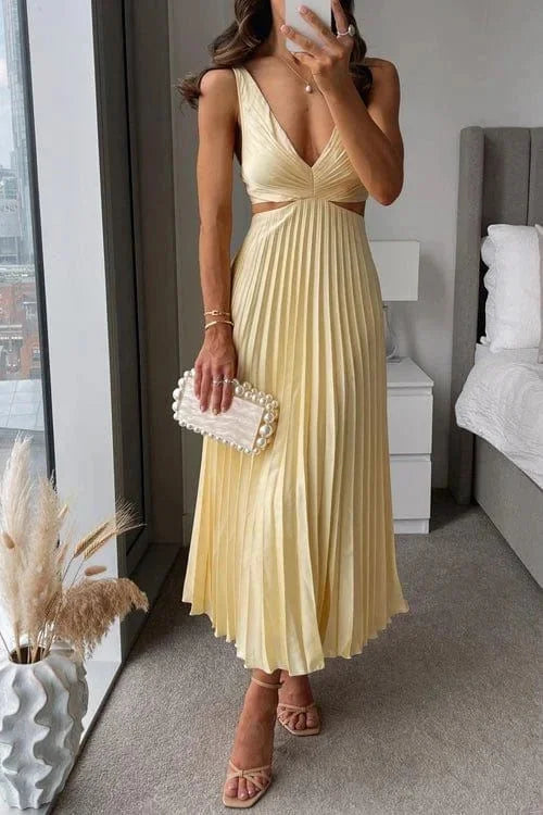 Yellow pleated midi dress with cut-out accents by Easton. Features a soft and flowy fabric perfect for special occasions.