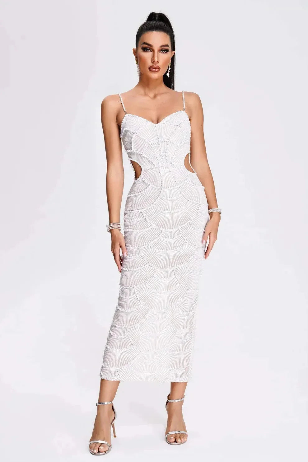 White sequined midi dress with straps, perfect for special occasions. Glamorous sequin detailing and adjustable straps for a…