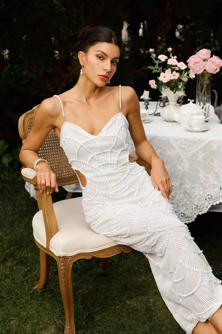 "White sequined midi dress with unique straps for women, perfect for formal occasions or parties. Shimmery and elegant…