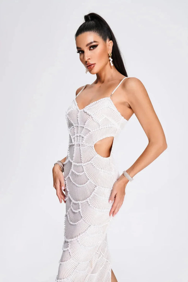 White sequined midi dress with thin straps on a mannequin. Perfect for special occasions with a glamorous and elegant design.