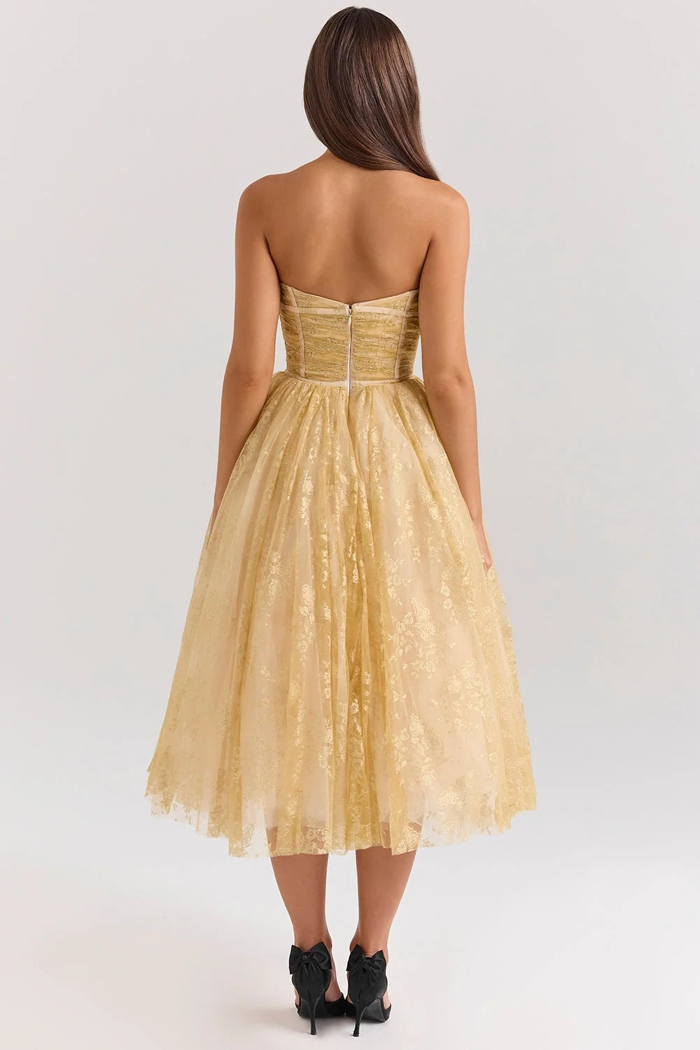 Strapless mid-length dress in golden floral pattern, perfect for special occasions.