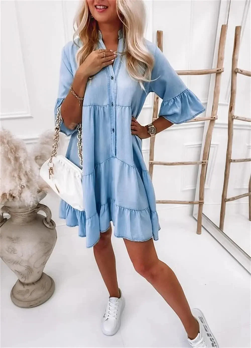 Light blue denim dress with tiered design, perfect for a casual chic look.