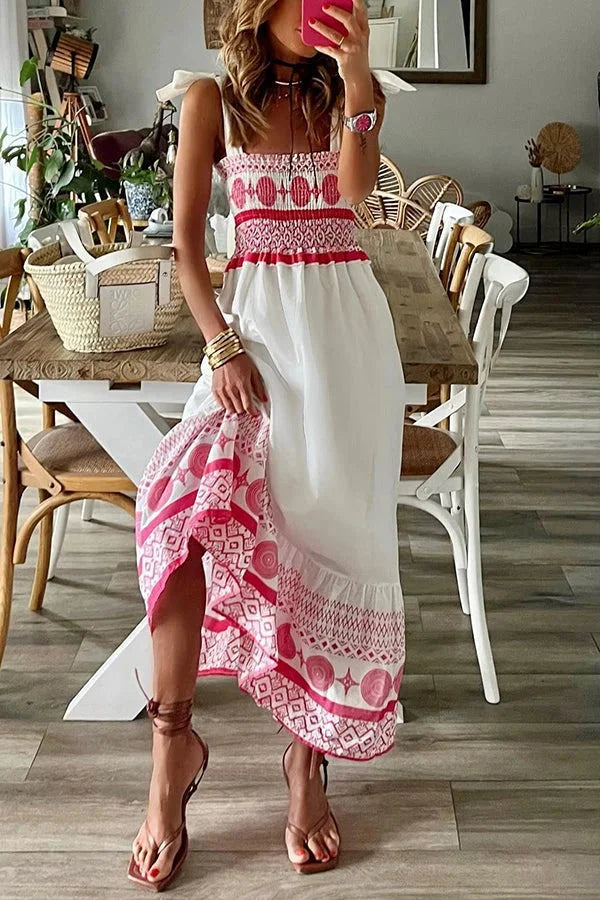 White maxi dress with pink tribal patterns, made of soft cotton blend fabric. Perfect for a bohemian chic look.
