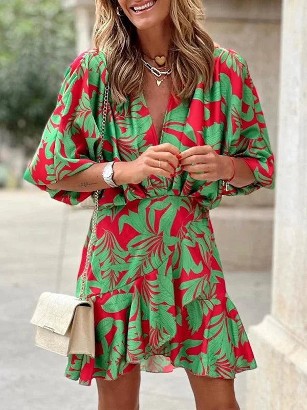 Red tropical print dress with flared sleeves, made of lightweight and flowing fabric. Perfect for a casual day out or beach…