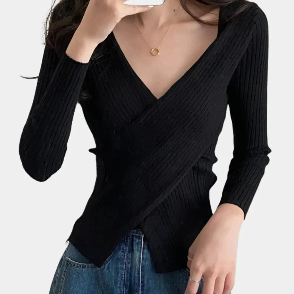 Black ribbed V-neck wrap top by Eliyah. Soft, stretchy fabric with a chic wrap design for a trendy and versatile look.