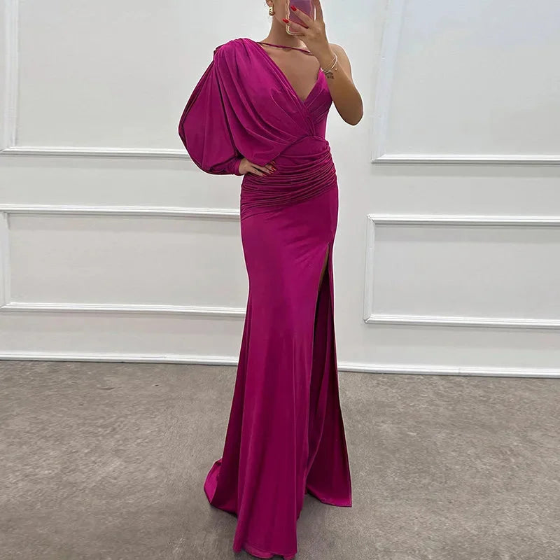 Pink Ellieanna dress with one-shoulder design and side slit. Made from soft, flowing material. Stylish and elegant for any…