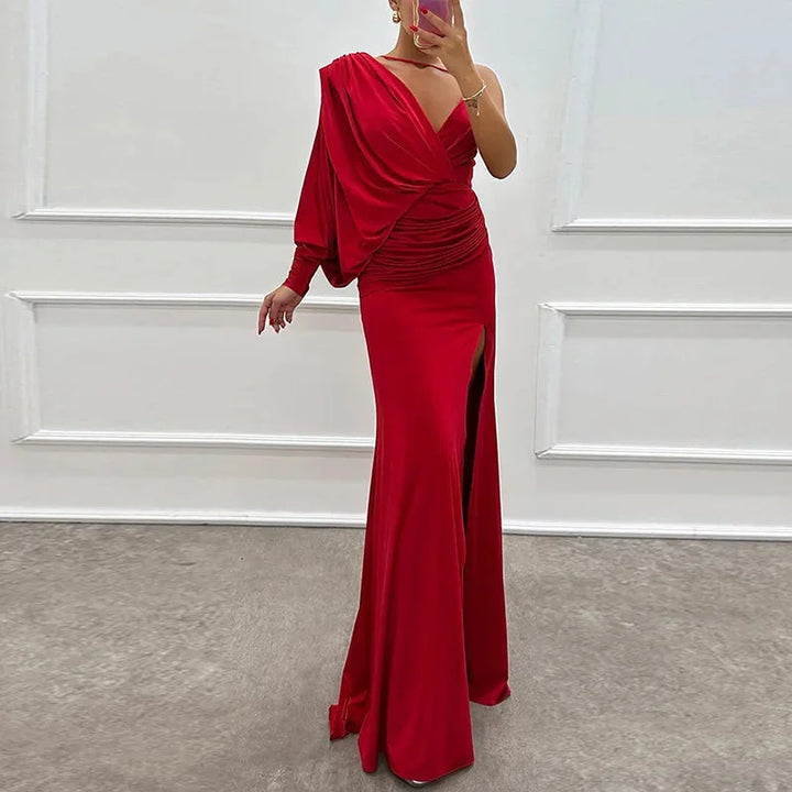 Red one-shoulder dress with side slit, made of sleek and soft fabric.
