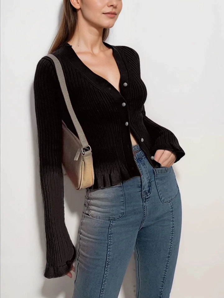 "Black ribbed cardigan with front buttons, perfect for layering. Soft and cozy knit fabric for warmth and comfort."