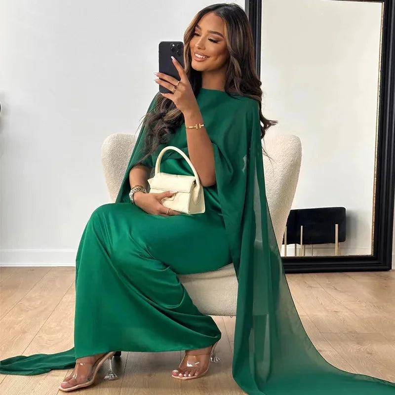 Green cape maxi dress with intricate lace detailing perfect for evening events. Silk chiffon material with a flowy and…
