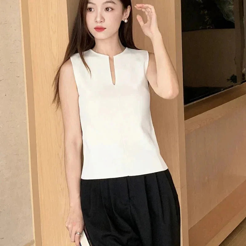 Sleeveless top in soft fabric with stylish keyhole detail at neckline for a chic and modern look.