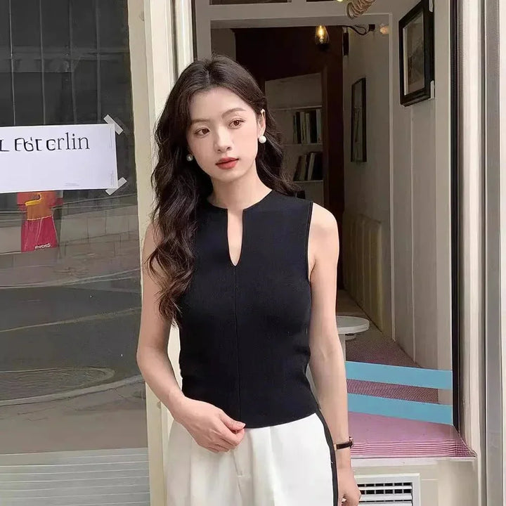 Black sleeveless top with keyhole detail. Made with soft stretch cotton blend. Chic and versatile addition to your wardrobe.
