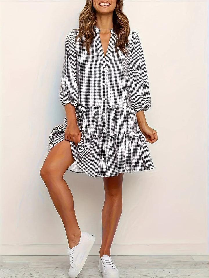 Black striped dress with collar and button details in soft, breathable fabric. Perfect for everyday wear with a touch of…