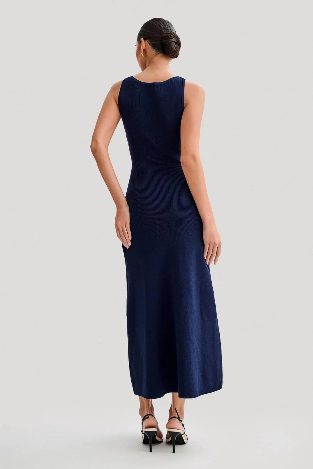 Sleeveless midi dress in blue with button front detailing, a flattering waist tie, and a flowy design by Freyja.
