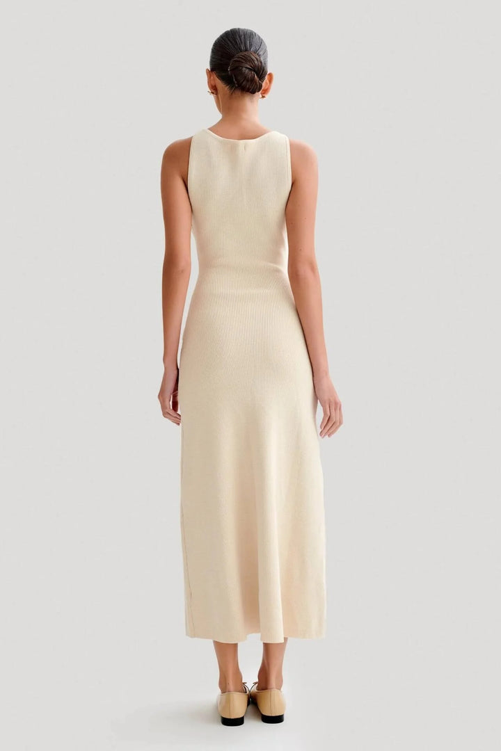 Sleeveless midi dress with button-front detail, made from soft rayon fabric in a classic and elegant design.