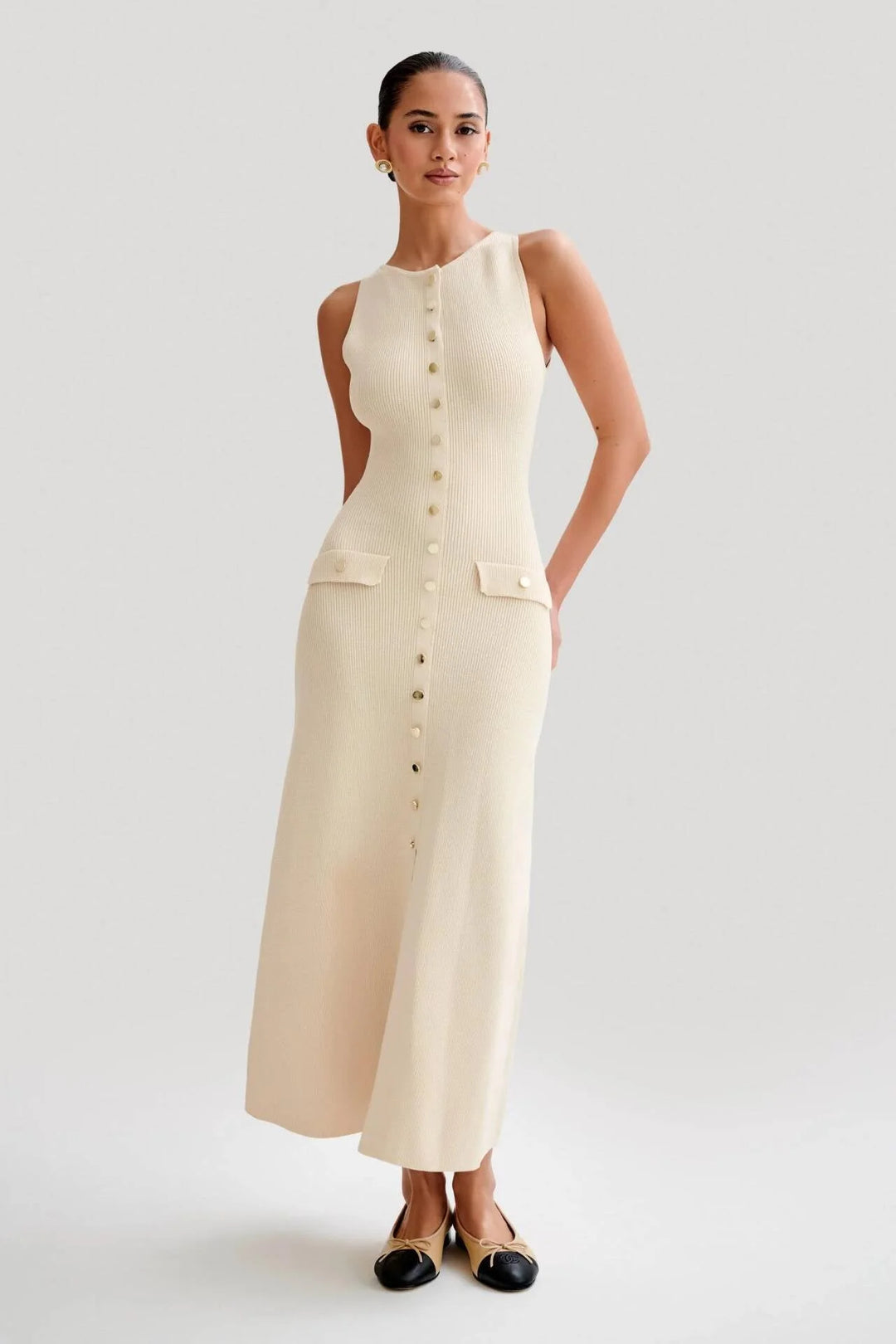 Sleeveless midi dress in Apricot, featuring button-front detailing and crafted from lightweight breathable fabric.