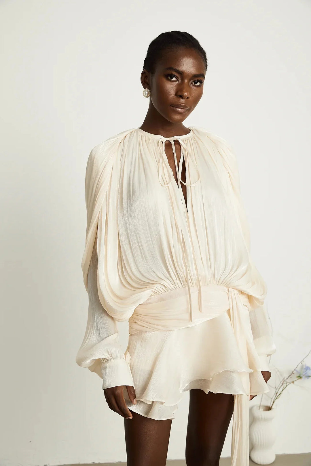 "Satin mini dress in Gabriella style with tie accents, flowing silhouette."