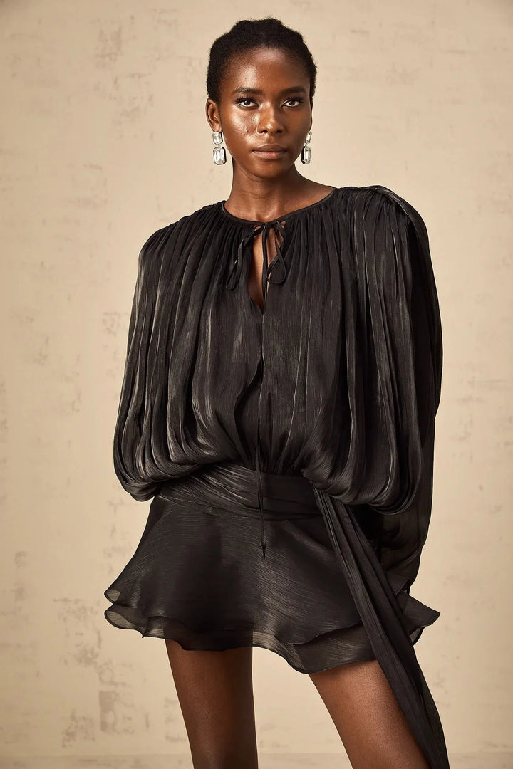 "Black satin mini dress with tie accents, flowing design, perfect for any occasion."