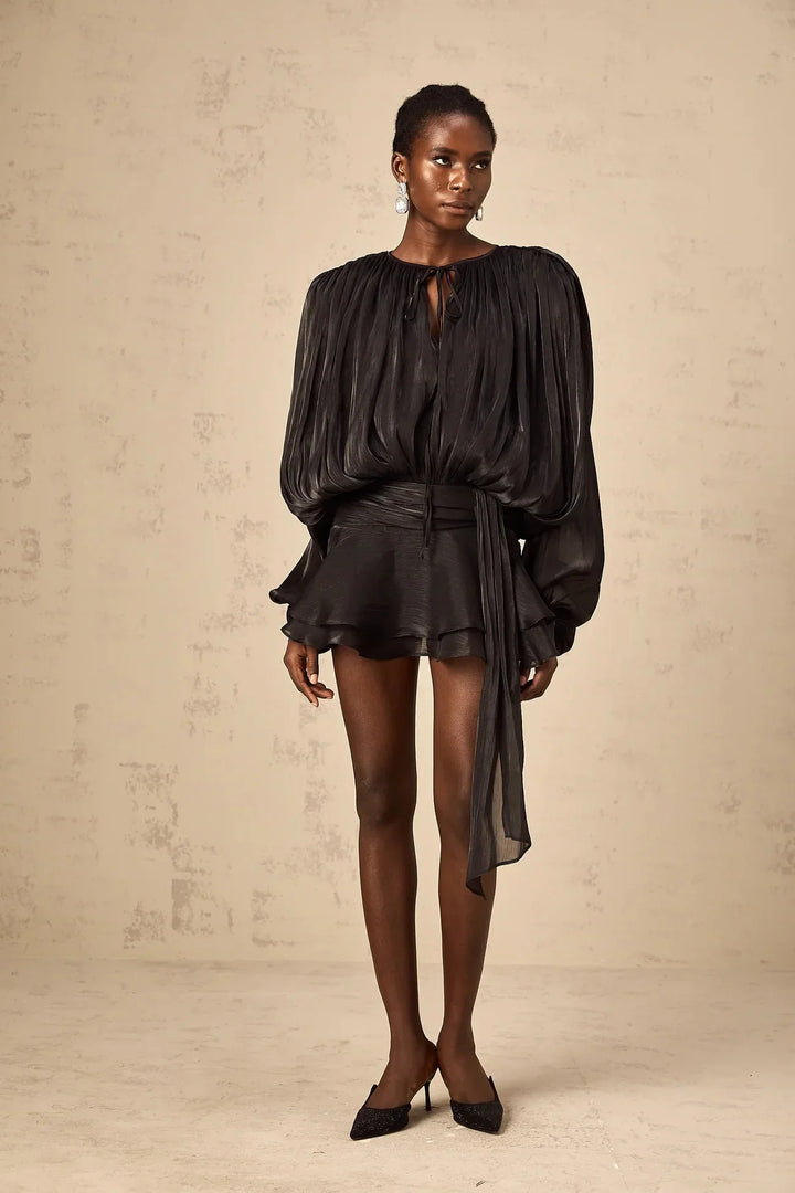Black satin mini dress with elegant tie accents, perfect for an evening out or special occasion. Feminine and chic design.