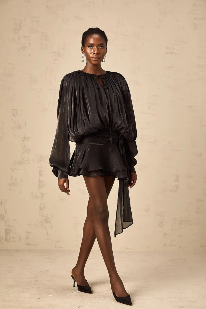 "Navy satin mini dress with tie accents, perfect for a night out with its flowing design and elegant details."