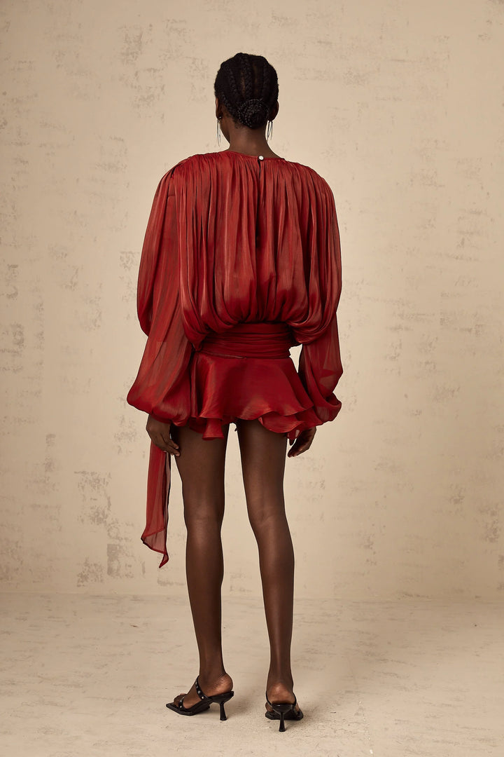 "Black satin mini dress with tie accents, fluid silhouette, elegant design."