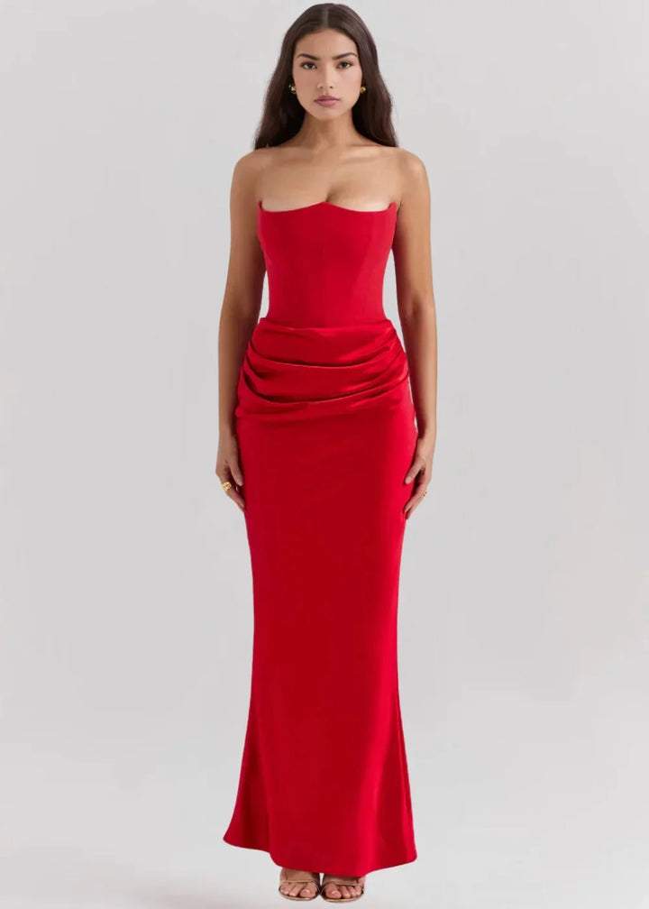 Red strapless evening attire in sleek, flowing fabric with a textured bodice and flowing skirt. Perfect for formal occasions.