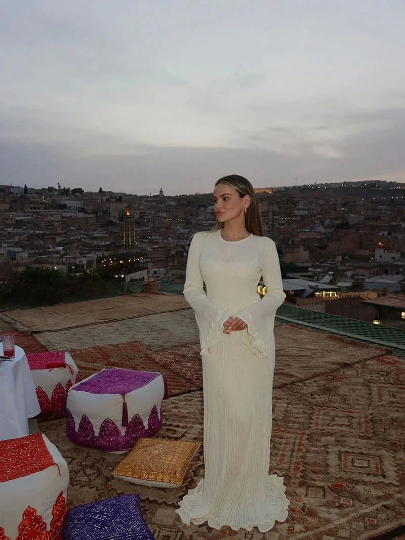 A floor-length dress featuring pleats, bell sleeves in soft chiffon fabric, perfect for special occasions.