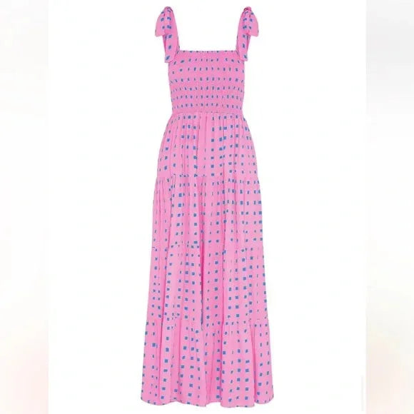 Pink smocked maxi dress with tie straps made of lightweight breathable cotton blend fabric, perfect for a casual summer look.
