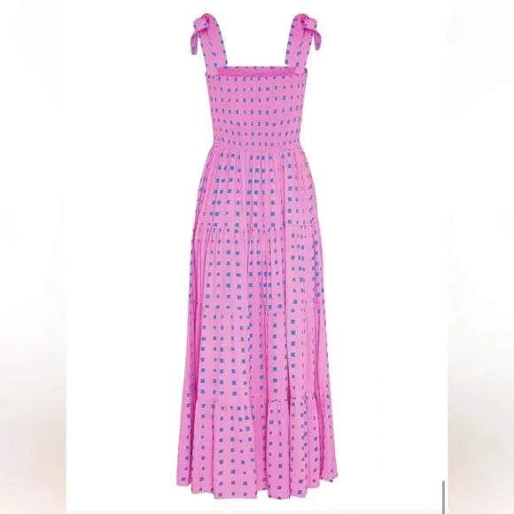 Pink smocked maxi dress with tie straps in soft chiffon material, perfect for summer days. Flattering design with feminine…