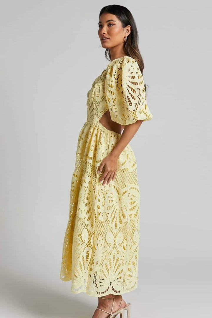 "Black lace dress with V-neckline, mid-length. Features delicate lace detailing and a flattering silhouette."