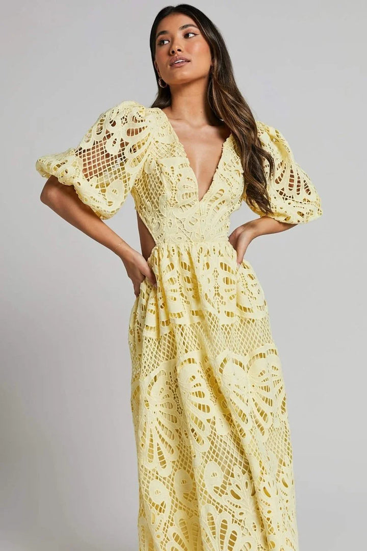 "Gracelynn mid-length lace dress with V-neckline in white, featuring intricate floral lace pattern and flattering…