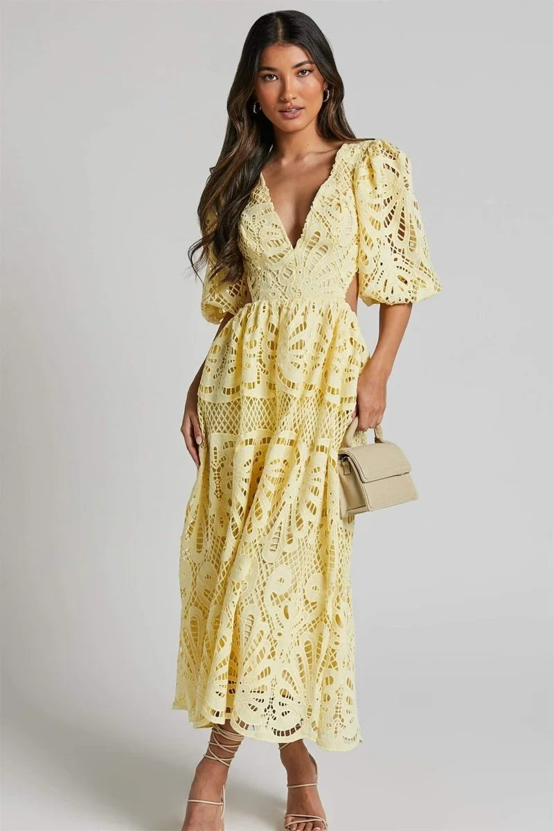 Yellow lace mid-length dress with elegant V-neckline and intricate design detail.