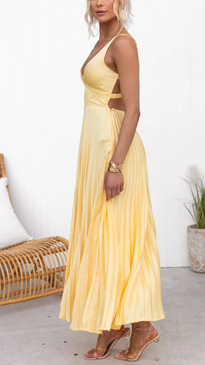 Yellow maxi dress made of flowy fabric, featuring a flattering v-neck design. Perfect for sunny days or special occasions.