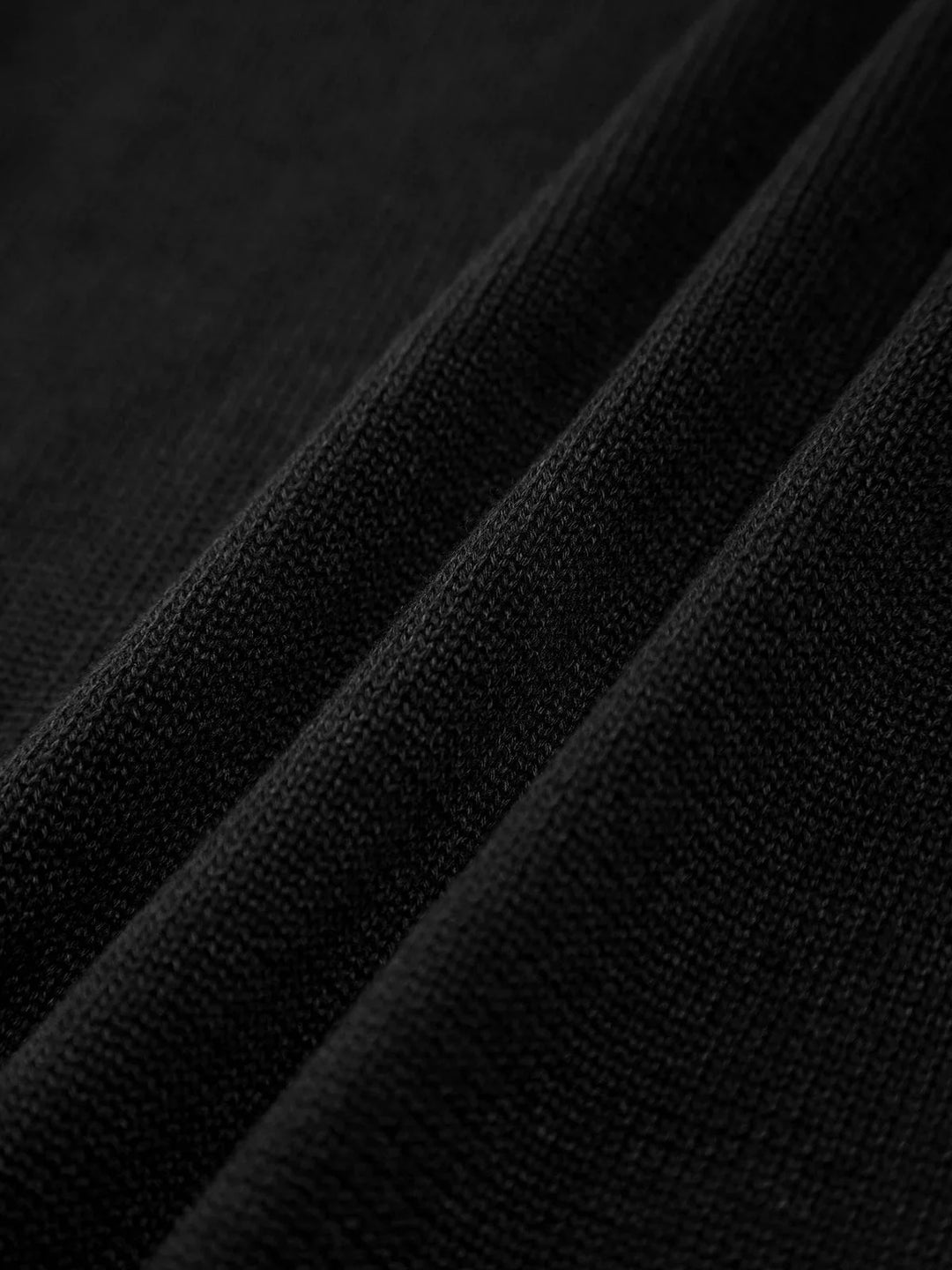 Black slim tank top with crisscross back straps made of soft, stretchy fabric.