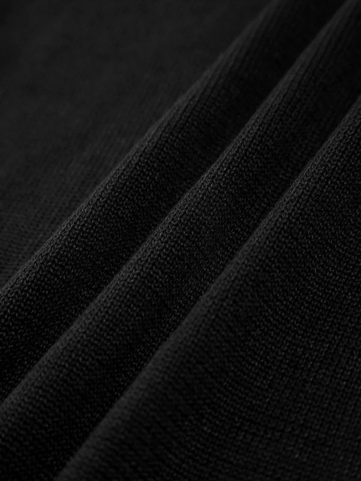 Black slim tank top with crisscross back straps made of soft, stretchy fabric.