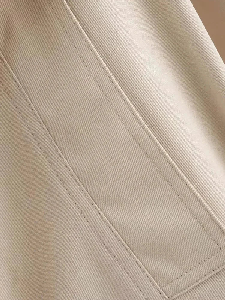 Beige cropped jacket with waist tie made of soft cotton blend material, perfect for casual and versatile styling.