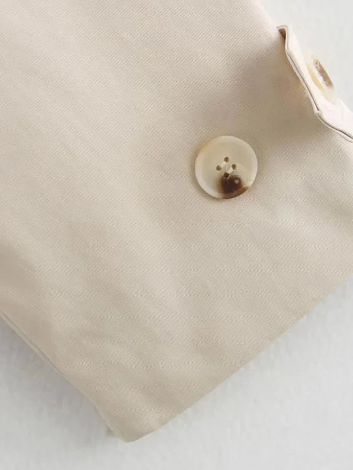 Beige cropped jacket with waist tie, made from soft, breathable fabric. Elegant design perfect for layering in any season.