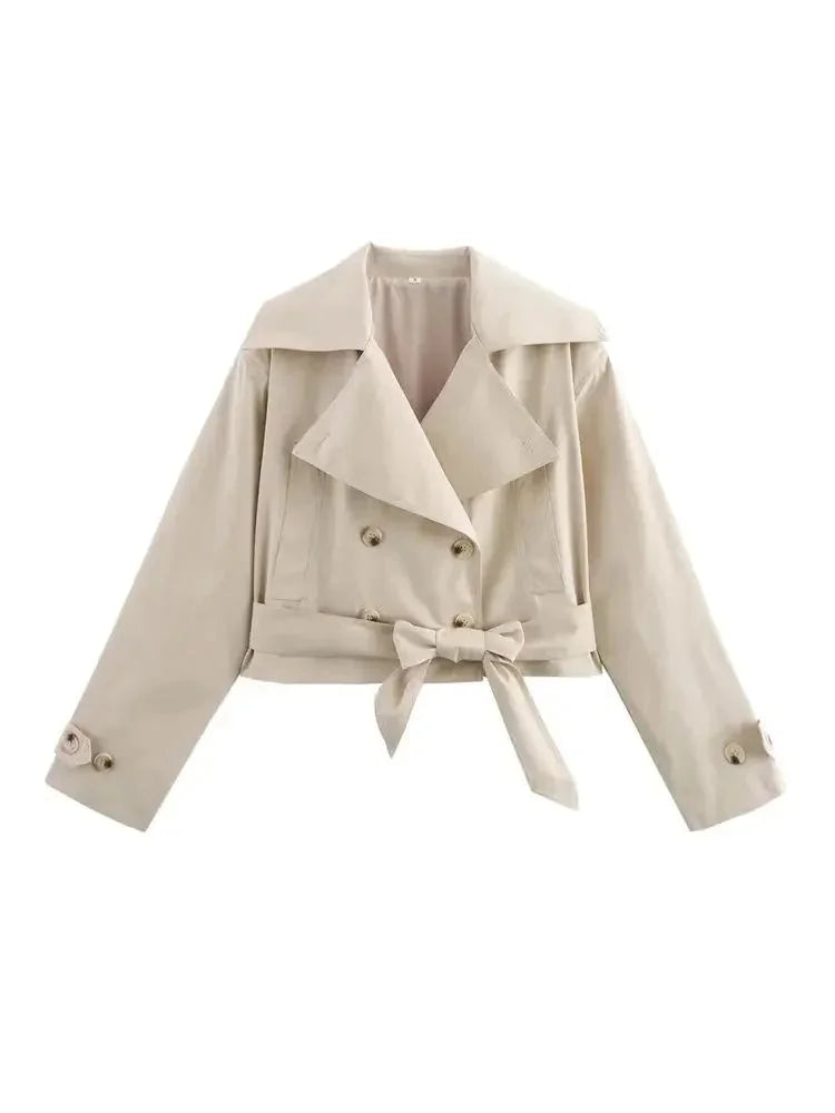 Beige cropped jacket with waist tie, featuring a tailored fit and made of textured fabric.
