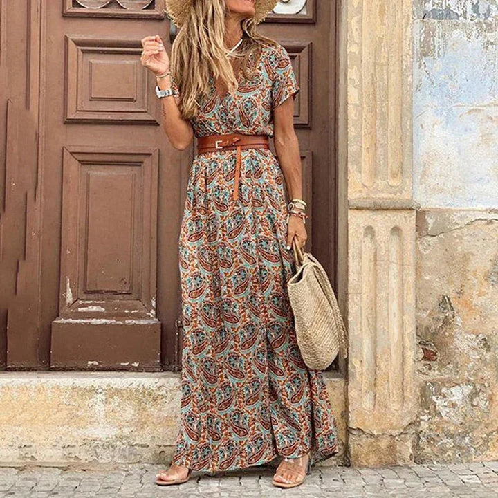 Brown V-neck maxi dress with floral print and belt. Made from a flowy fabric suitable for casual or formal occasions.