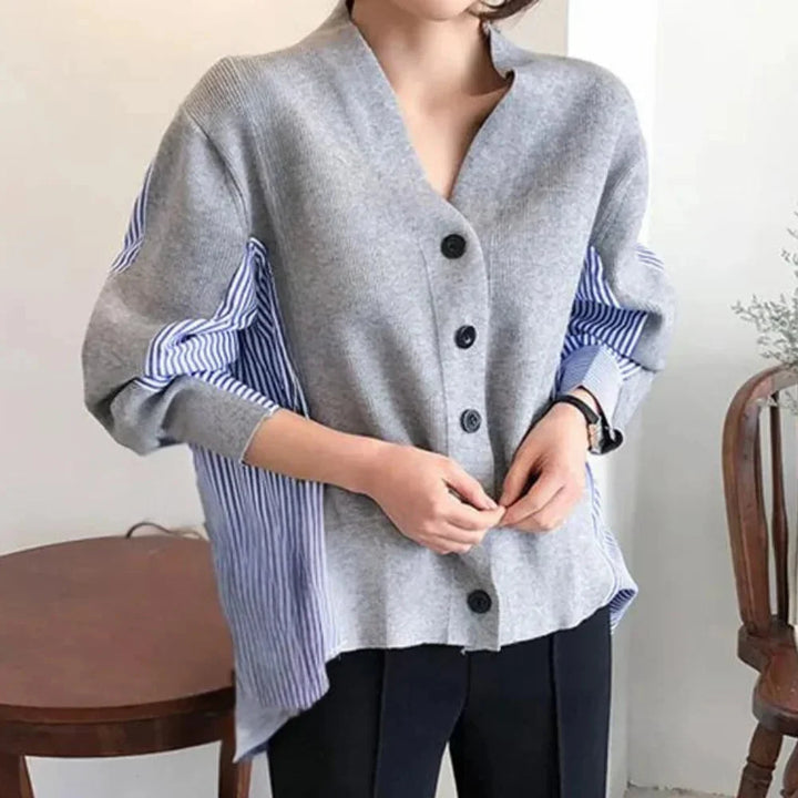 Grey cardigan with striped sleeves, perfect for a casual-chic look. Made of soft, lightweight fabric for all-day comfort.