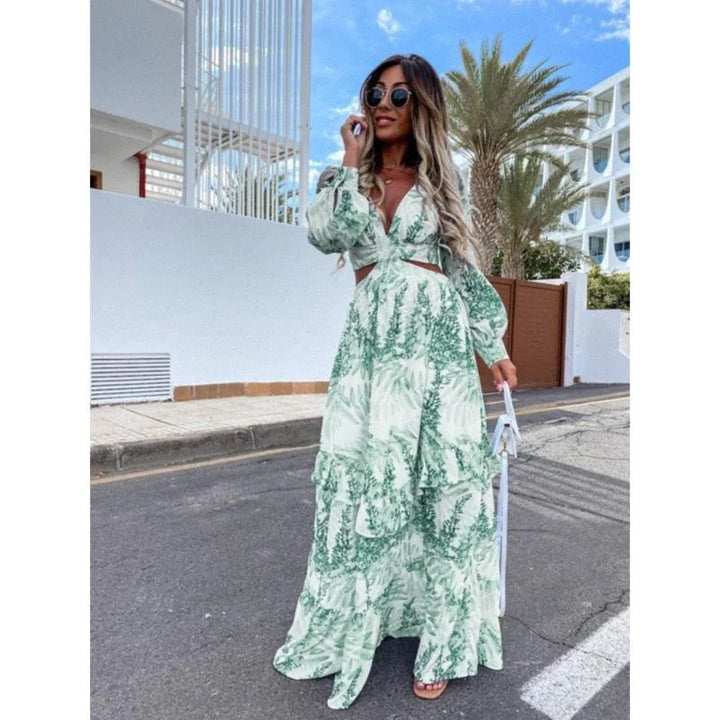 Green flowy maxi dress with floral print. Made of lightweight fabric, perfect for a breezy summer day.