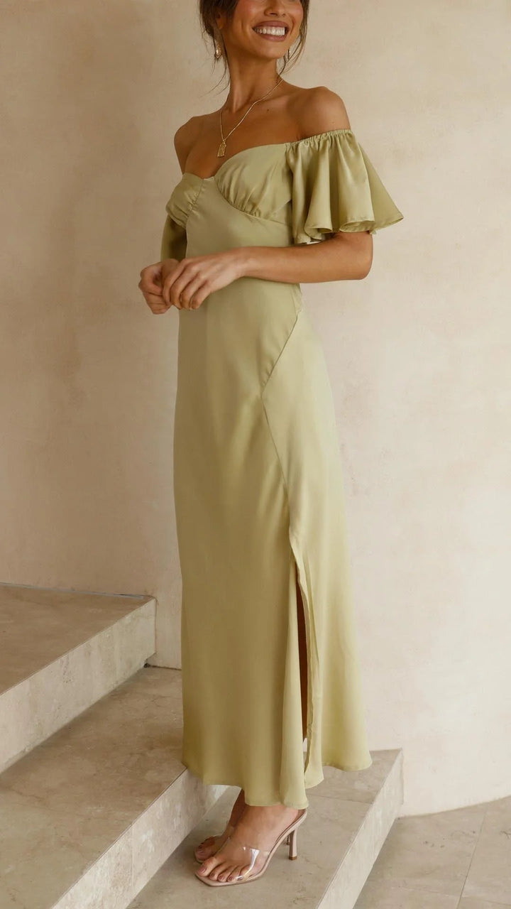 Off-shoulder maxi dress with slits in flowy fabric. Elegant and versatile design perfect for a casual or dressed-up look.