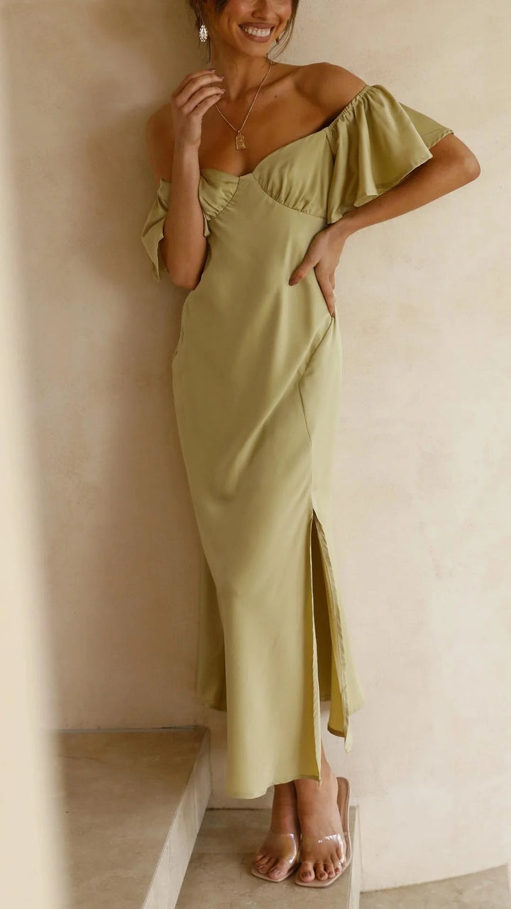 Off-shoulder flowy maxi dress with slits in soft, breathable fabric. Feminine and flattering design for a breezy summer look.