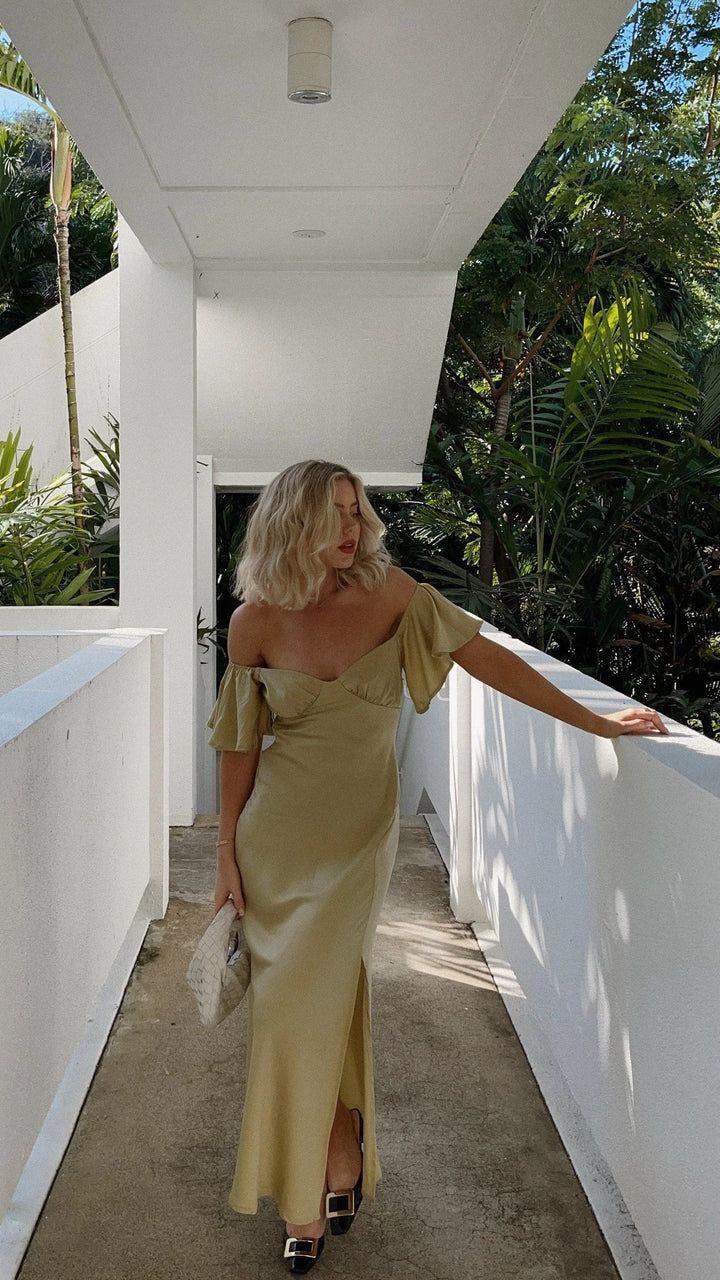 "Flowy off-shoulder maxi dress in a soft, breathable fabric with thigh-high slits for a stylish and comfortable summer look."