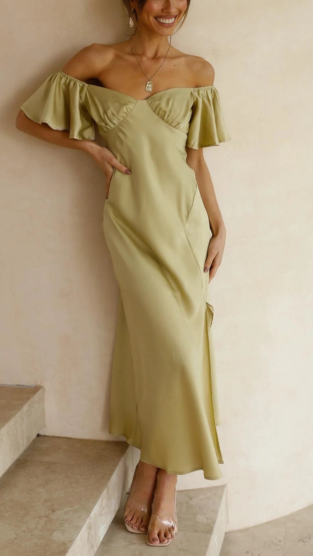 Off-shoulder maxi dress made of flowy fabric with stylish slits. Perfect for a chic and feminine look.