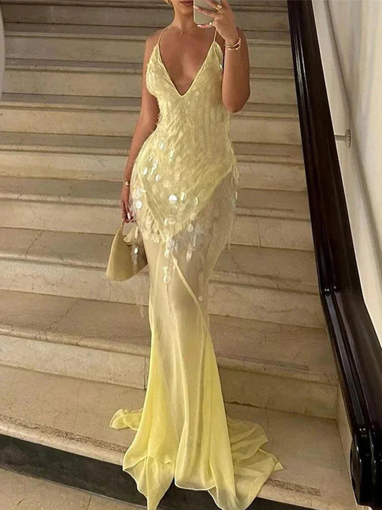 Sheer yellow maxi dress with sequins, perfect for a sunny day out or special event.