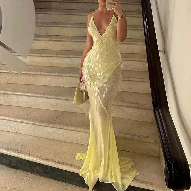 Sheer yellow maxi dress with sequins detail, perfect for a glamorous look at special occasions.